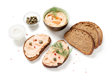 Smoked salmon and soft cheese spread  pate with brown bread and capers isolated on white background.