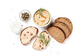 Smoked salmon and soft cheese spread  pate with brown bread and capers isolated on white background.