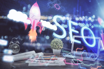 Multi exposure of table with computer and seo drawing hologram. Search optimization concept.