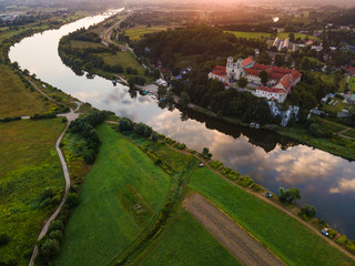 Benedictine Abbey and Monastery on the Hill in Tyniec near Cracow, Poland. Riverside of Vistula River at Sunrise. Drone View.