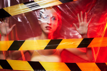 Portrait of unhappy, upset girl, can no breathe. Young woman is choking, wrapped in plastic bags,...