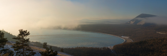 Sayan mountains in the fog on lake Baikal.
