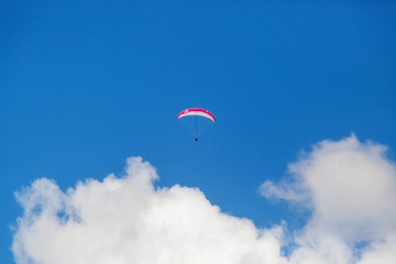 Paragliding in the sky on a sunny day.