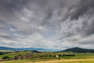 Wide angle view of a small hungarian village with catholic church in Transylvania, Romania.