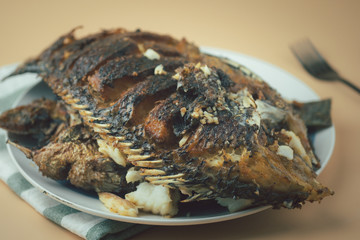 Deep fried Tilapia fish after fried on dish ready to eat
