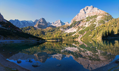 Fototapeta na wymiar idyllic mountain lake Seebensee in the morning with perfect water reflection