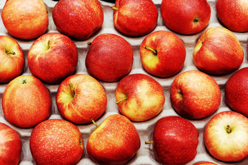 Fototapeta na wymiar Red apples in a carton. Fresh fruit trade in a store