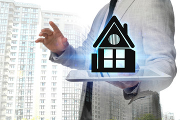 Double exposure of real estate agent with house illustration over tablet and apartment building