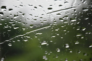 Raindrops on the windshield with blurred background. (Selective focus)