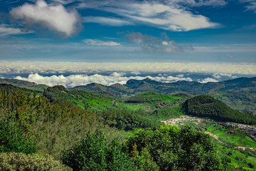 Fototapeta na wymiar mountain range with cloud layers and green forest