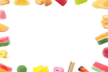 Frame of different tasty candies on white background