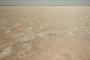 Close-up of sand on the beach of the salty pink lake Bursol (Altai Territory).
