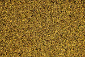 Yellow painted gravel texture. Tiny stones background.