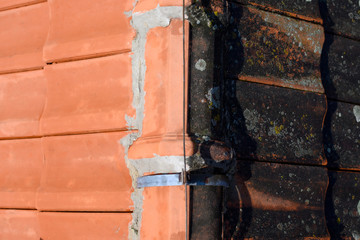 Same roof tiles before and after washing with compressed water. Half of job done. Cleaned dirt and lichens.