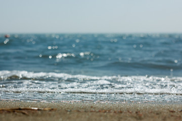 Close-up of sand on the beach and water of the Yarovoe salt lake (Altai Territory).