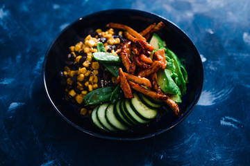 plant-based food, vegan poke bowl with beans corn avocado cucumber and air fried marinated tofu