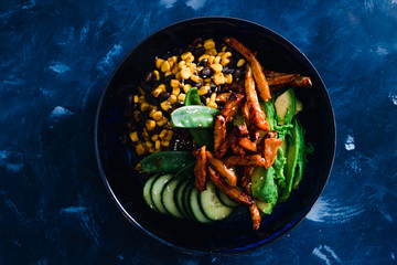 plant-based food, vegan poke bowl with beans corn avocado cucumber and air fried marinated tofu