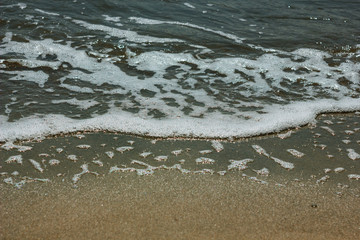 Close-up of sand on the beach and water of the Yarovoe salt lake (Altai Territory).