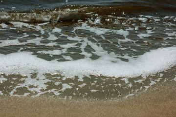 Fototapeta na wymiar Close-up of sand on the beach and water of the Yarovoe salt lake (Altai Territory).