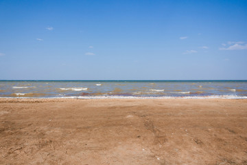 Close-up of sand on the beach and water of the Yarovoe salt lake (Altai Territory).