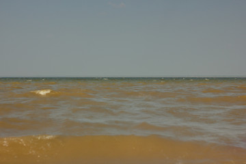 Close-up of sand on the beach and water of the Yarovoe salt lake (Altai Territory).