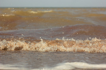 Close-up of sand on the beach and water of the Yarovoe salt lake (Altai Territory).