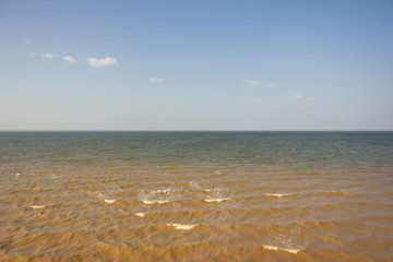 Close-up of sand on the beach and water of the Yarovoe salt lake (Altai Territory).