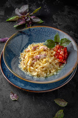 Gourmet delicious tagliatelle carbonara pasta cooked with cheese, egg, bacon and cream sauce. Balanced nutritious dish. Still life for restaurant poster