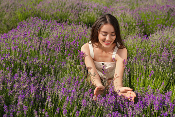 Young woman in lavender field on summer day