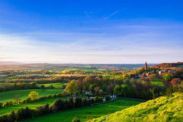 Fototapeta na wymiar View of Abberley clock tower at sunset during late April from Walsgrove hill near Great Witley in Worcestershire west midlands England