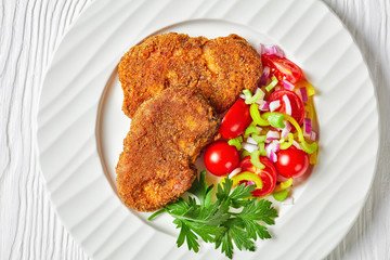 breaded lamb chops served with veggies salad