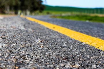 Roadway closeup in the country with yellow line