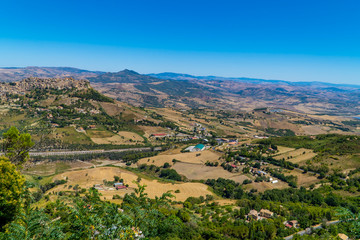 The landscapes of central Sicily, Italy with villages and the town of Leonforte on the hill