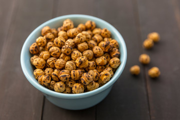 Roasted Chickpea in a bowl on wooden background. Turkish known as leblebi