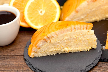  Creamy orange cheesecake and acoffee on table