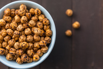 Roasted Chickpea in a bowl on wooden background. Turkish known as leblebi