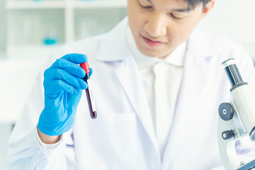 Scientist covid-19 virus chemistry  research experiment biotech antibody sample laboratory cultivate vaccine against virus. Scientist look at microscope, science test tube analyse Chemistry laboratory