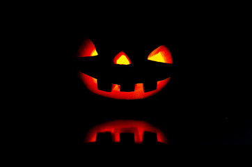 Photo of the Scary pumpkin smile for Halloween with reflection.