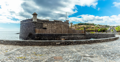 A panorama view in Santa Cruz, Tenerife towards the front of the Castle of  Juan Bautista on a sunny day