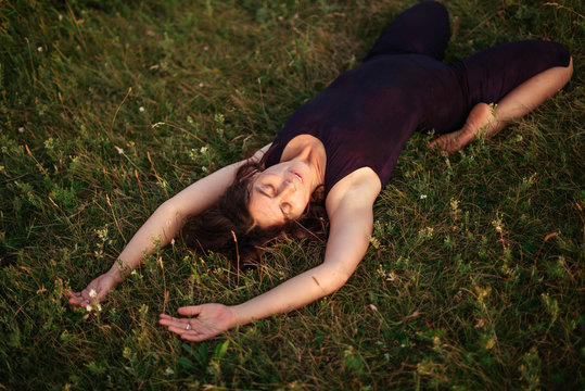 Yoga practice and meditation in nature in sunrise. Woman practicing near big river Kama.