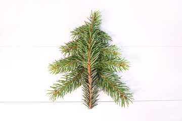 Flat shape of a Christmas tree on a white background. concept for festive xmas card with xmas branches, 2021