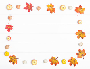 Fototapeta premium Autumn leaves and apples on a light wooden background