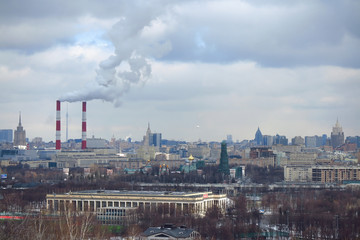 Smoke coming out of the chimneys of a thermal industrial station during winter in Moscow, Russia.