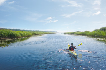 A man in a kayak on the river. Aerial view.