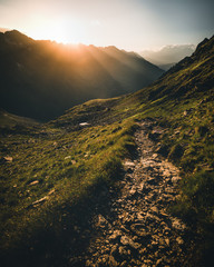 colorful sunset on top of austrian mountain alps