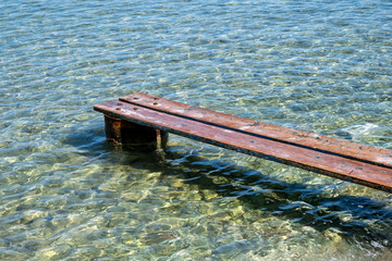 Weathered wooden small pier over the sea at Kea, Tzia island, Greece.
