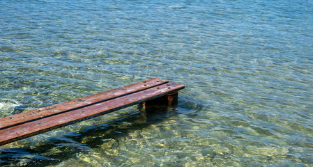 Weathered wooden small pier over the sea at Kea, Tzia island, Greece.