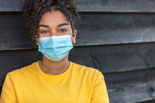 African American female young woman wearing face mask in Coronavirus COVID-19 pandemic