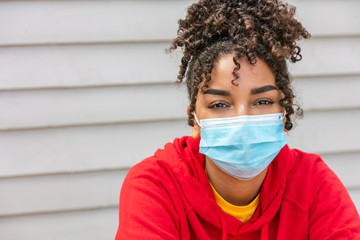 African American female young woman wearing face mask in Coronavirus COVID-19 pandemic