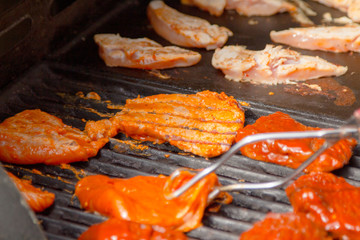 Grilling meat on gas grill at sunny day